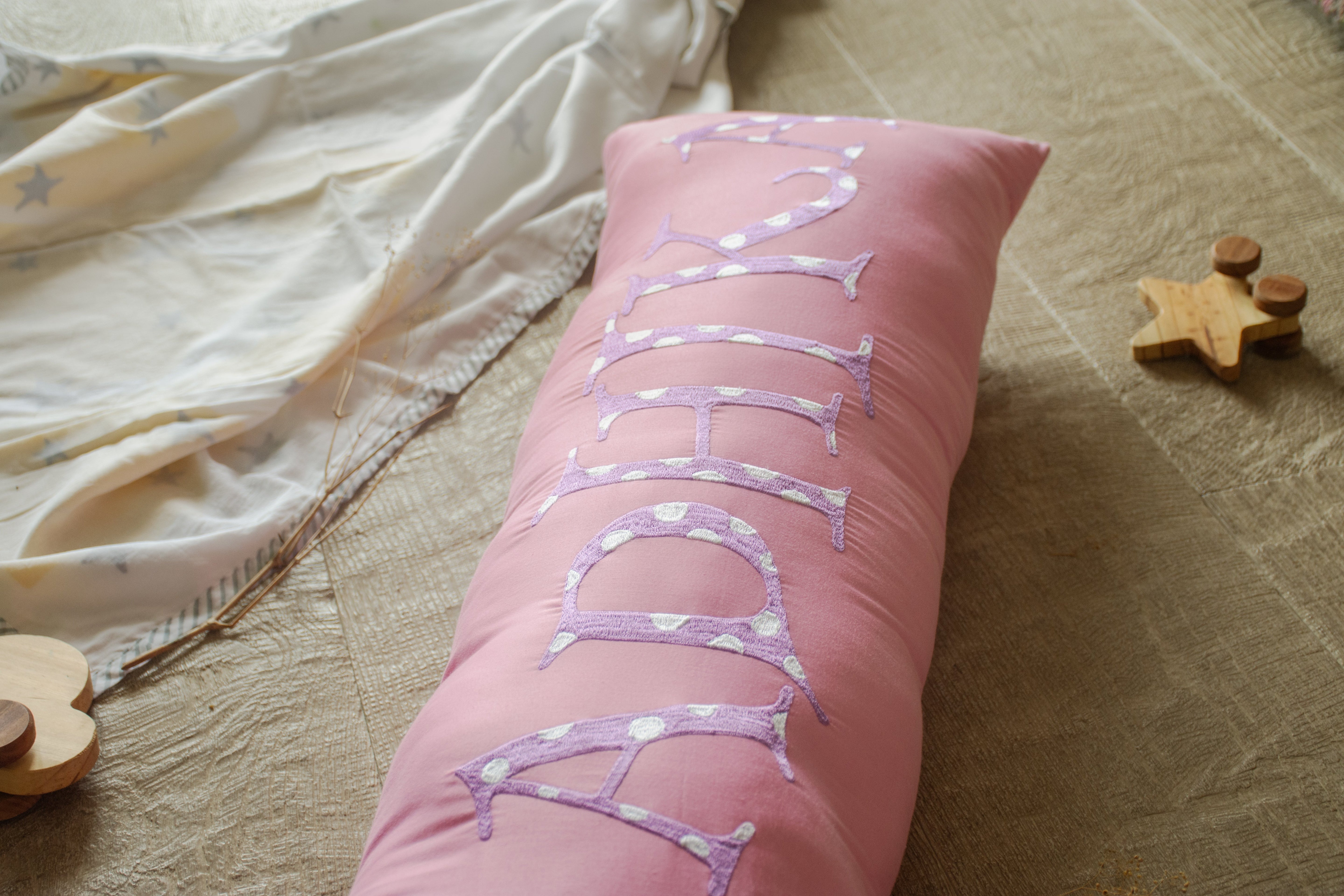 Personalized pink & purple embroidered name bolster pillow, ultra-soft and perfect for kids' rooms or as a cot bumper