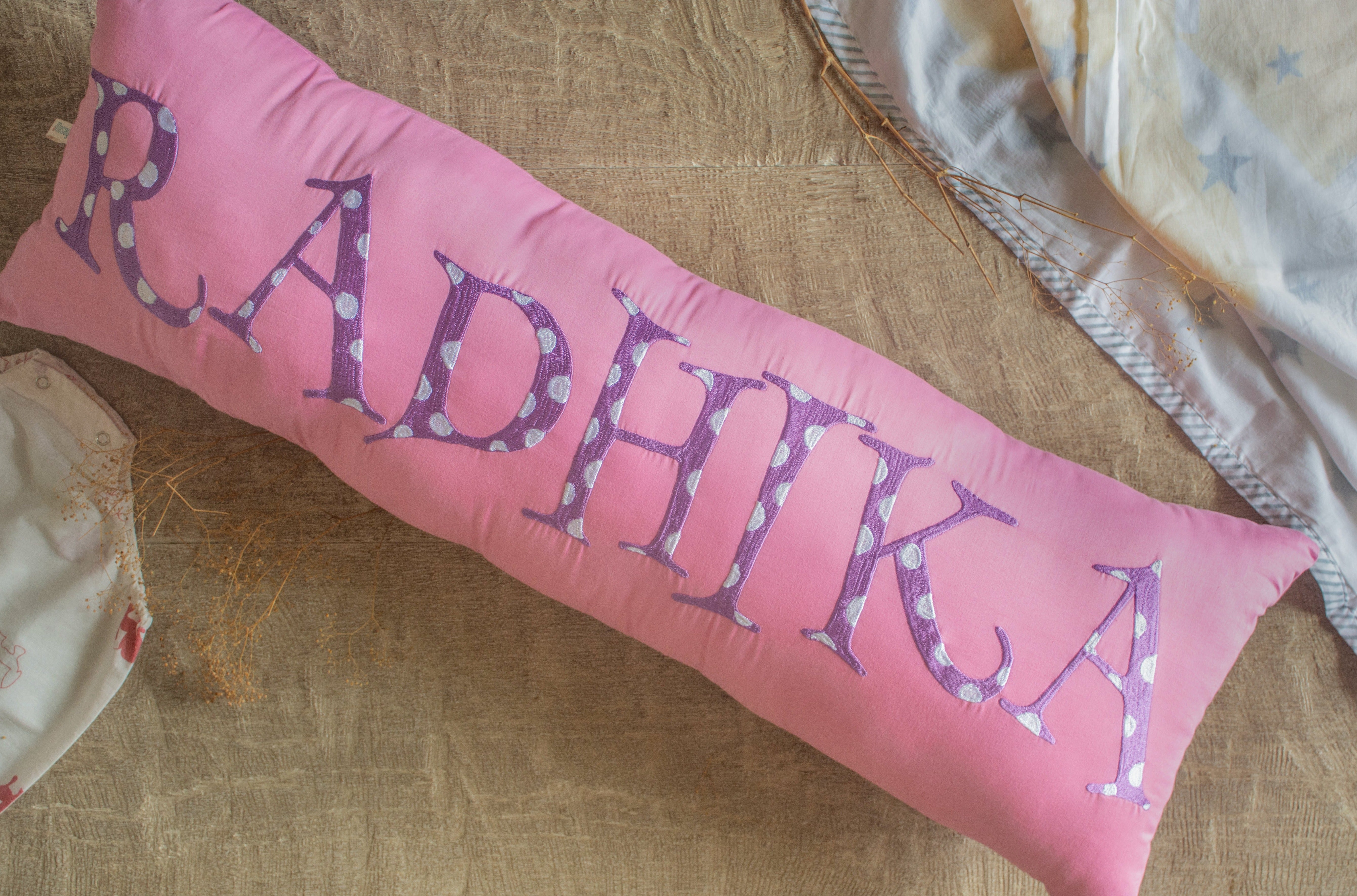 Personalized pink & purple embroidered name bolster pillow, ultra-soft and perfect for kids' rooms or as a cot bumper