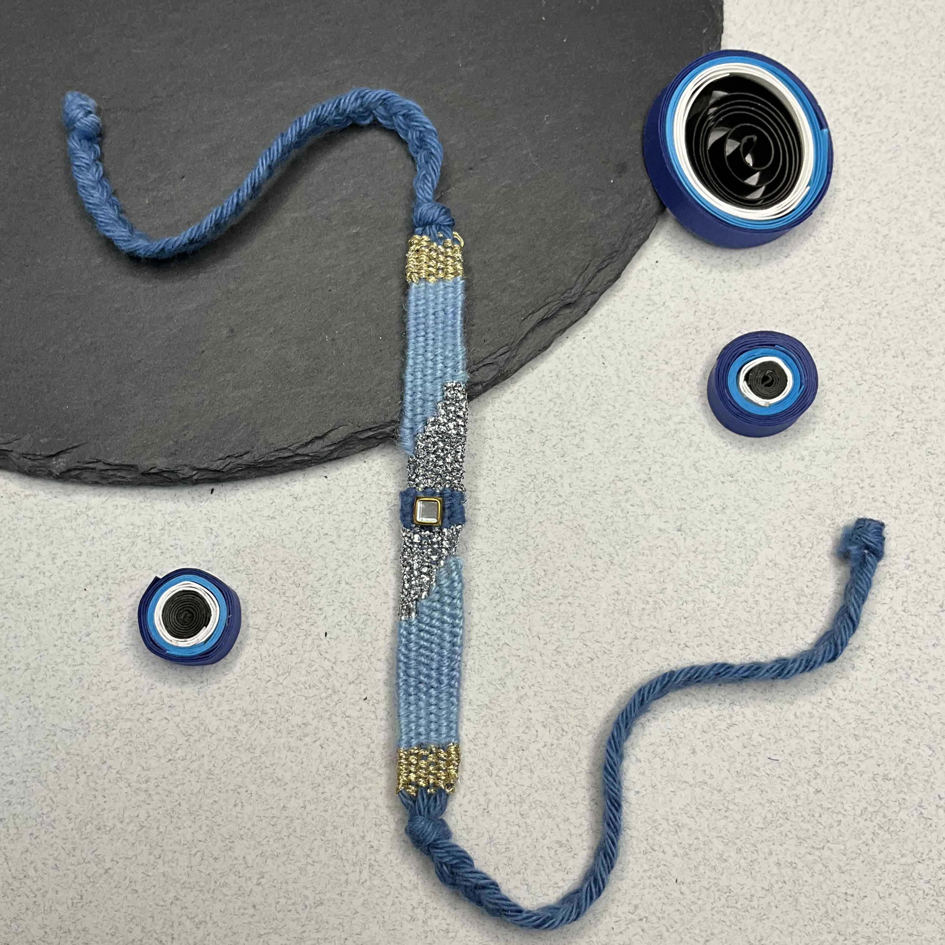 Hues Of Blue With Silver Weaved Threads Rakhi